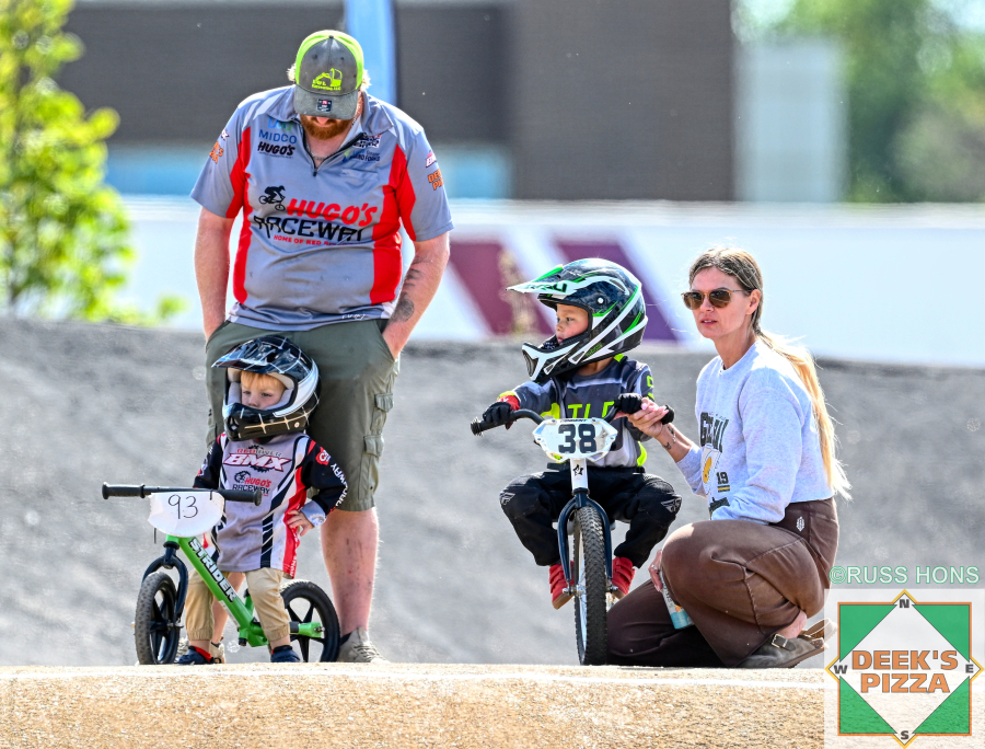 Families and young riders preparing for balance bike racing