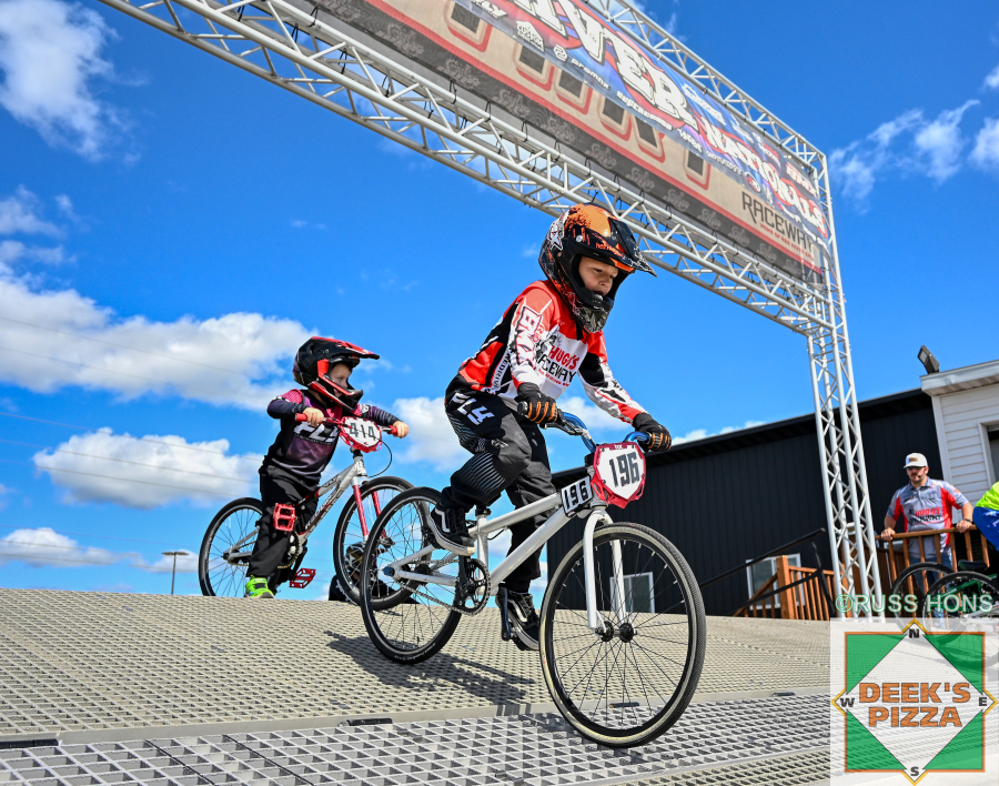 BMX riders launching from the start hill