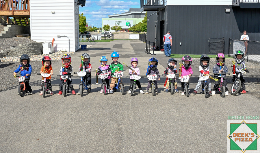 Balance bike riders with trophies at Hugo's Raceway