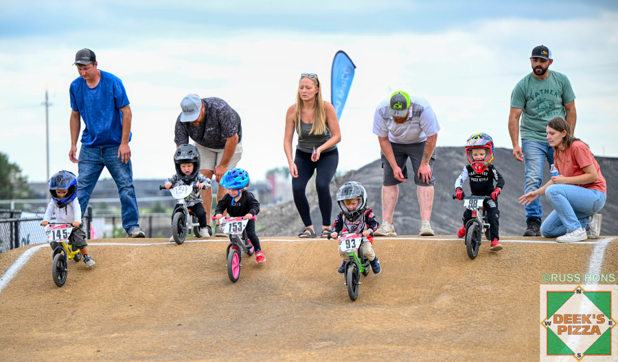 Balance bike riders racing with families at Hugo's Raceway